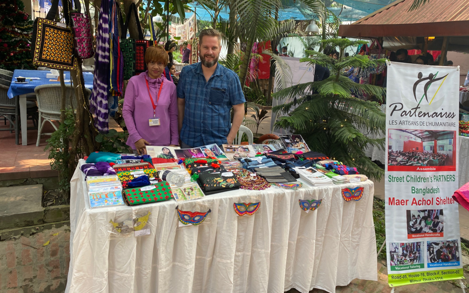 It Starts With Me: Aurelie Rob, Patrick Schraets and Sebastian Zak at MAER ACHOL 3 Patrick at the Maer Achol stall in the Dutch Club Charity Bazaar